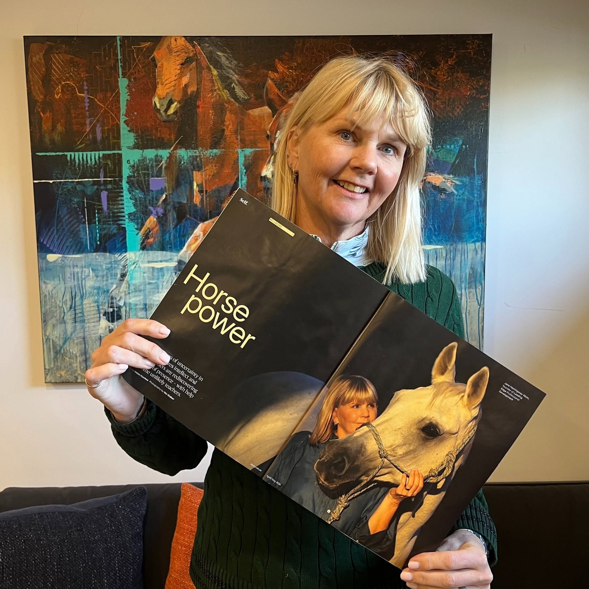 Jane Hemingway-Mohr holding the Australian Institute of Company Directors Magazine featuring her work in Equine-Assisted Learning leadership development.